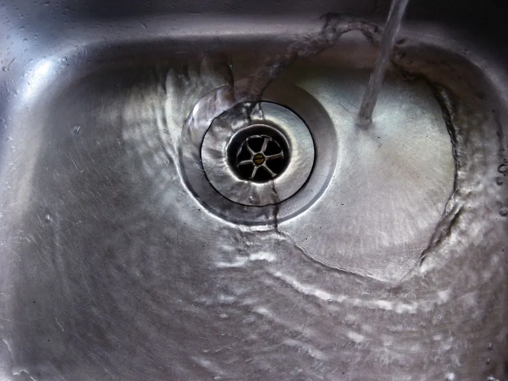 Household sink drain with water flowing