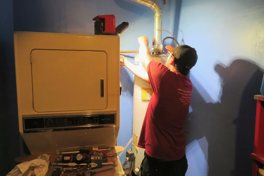 Technician working on a residential tank water heater
